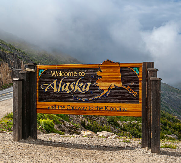 Welcome to Alaska sign in nature 
